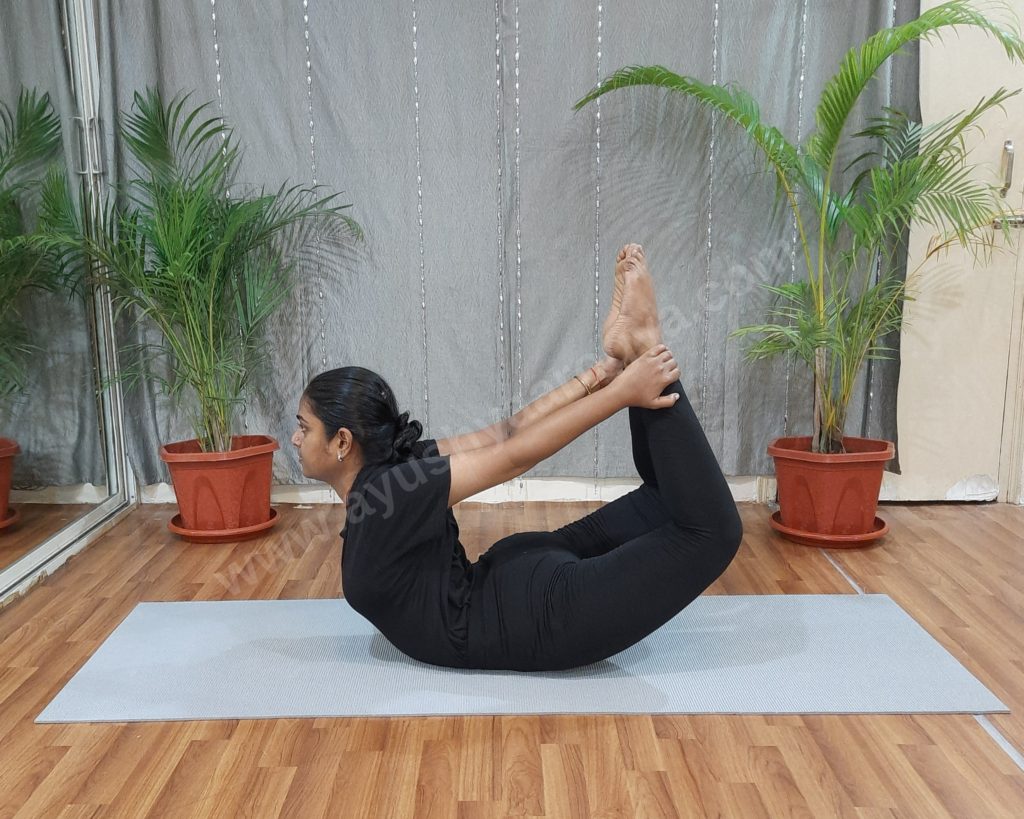Dhanurasana, the bow pose, practised on a mat